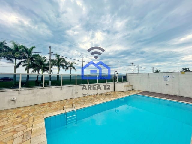 Foto do Apartamento - Apartamento à Venda no bairro do Massaguaçu, com 2 dormitórios e sacada com vista pro mar, banheiro, vaga para 1 carro na garagem em Caraguatatuba SP | Área 12 imóveis