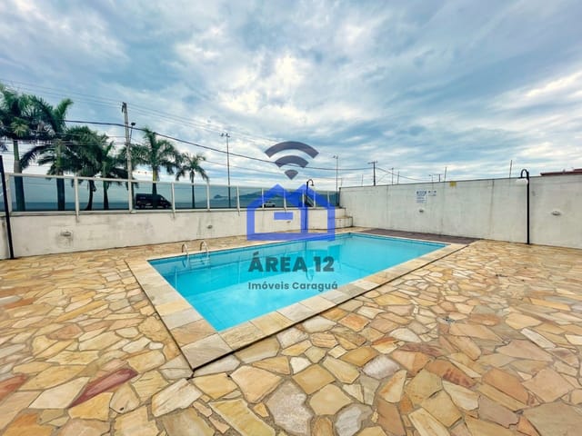 Foto do Apartamento - Apartamento à Venda no bairro do Massaguaçu, com 2 dormitórios e sacada com vista pro mar, banheiro, vaga para 1 carro na garagem em Caraguatatuba SP | Área 12 imóveis
